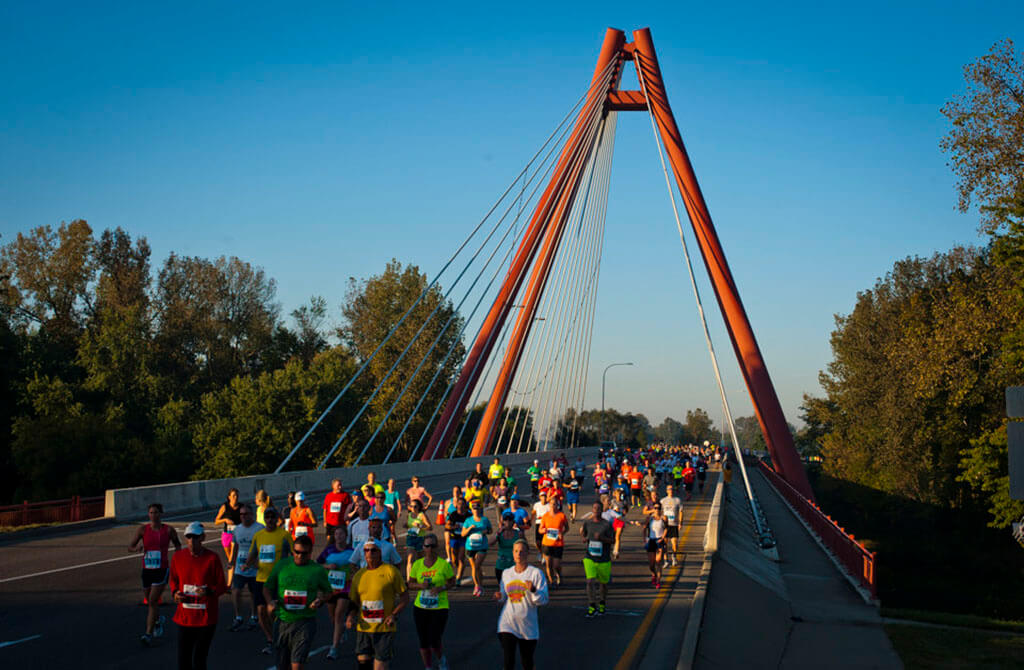 Runners cross Robert N. Stewart bridge in downtown Columbus during the annual Mill Race Marathon