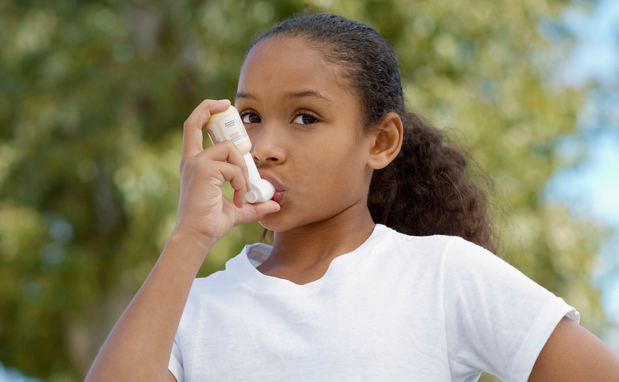 Child using asthma inhaler