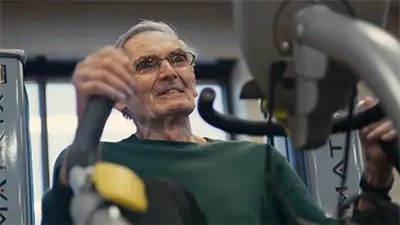 Watchman implant patient Fred Belcher working out on exercise equipment.