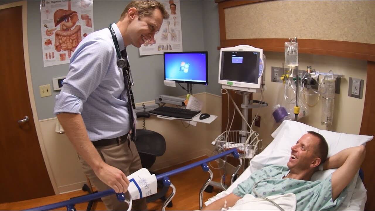 Gastroenterologist Patrick Barrett, MD, talks to patient Brad Davis before performing his colonoscopy.