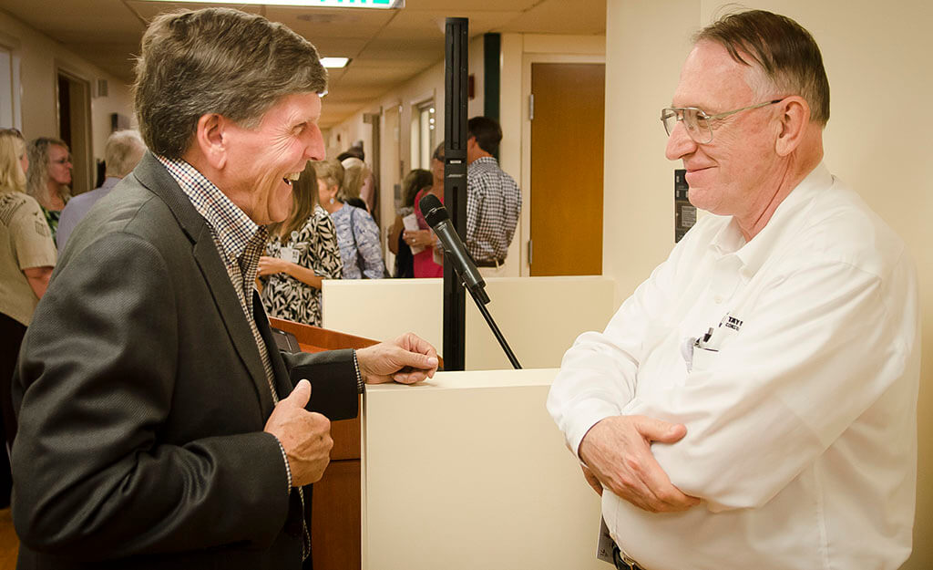 Zack Ellison, left, and David Doup chat at the VIMCare Open House.